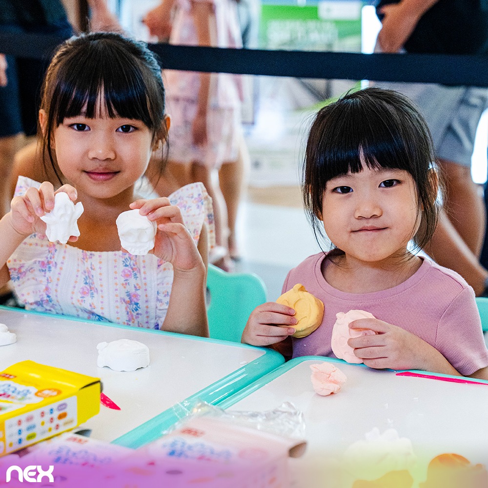 A family posing in a Halloween photobooth setup