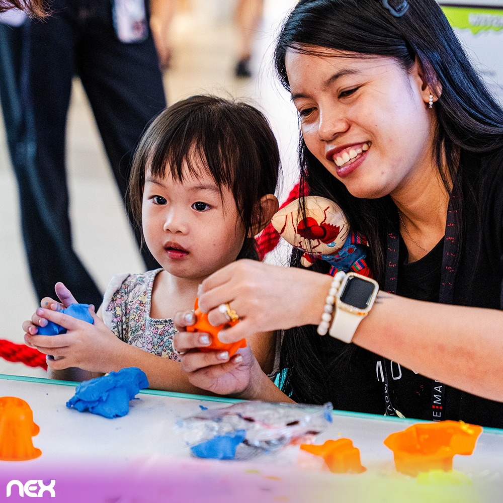 An artist painting a child's face at an event