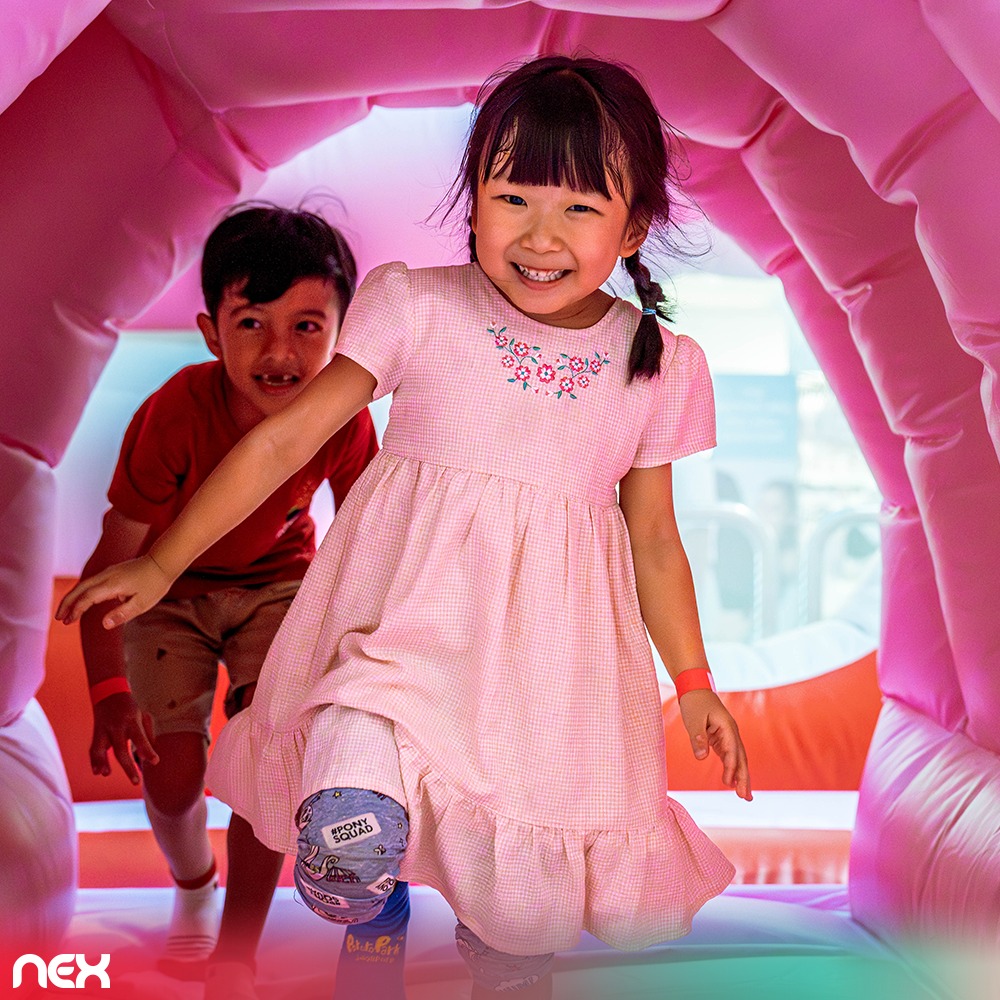 Children playing on a multi-tiered cake slide in the minini Playland