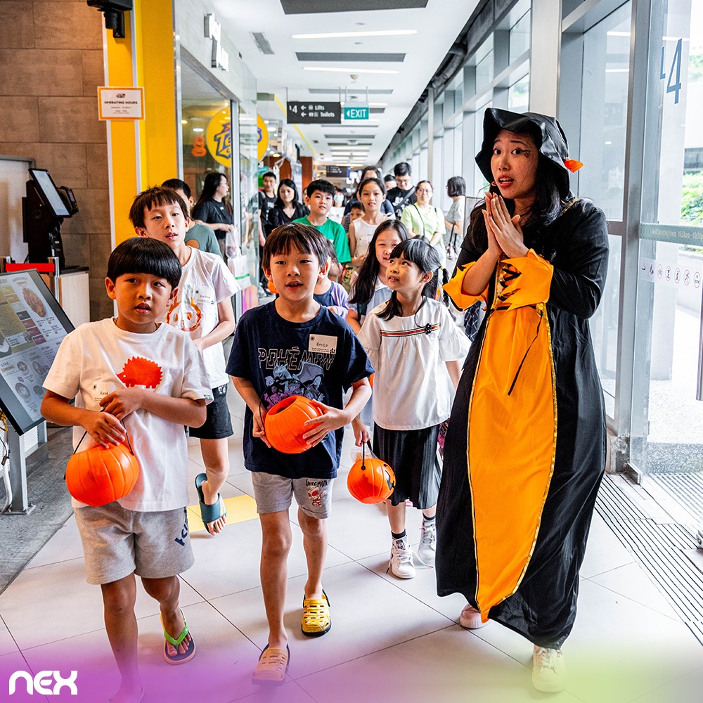 Kids joyfully collecting treats during a Halloween event